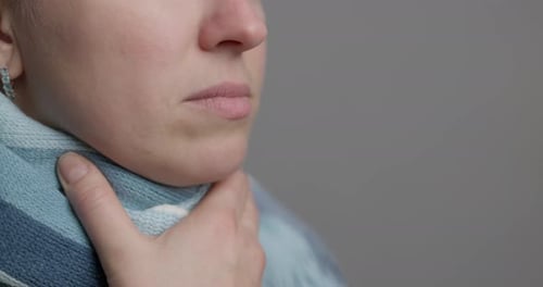 Adult Woman Using Throat Spray for Sore Throat