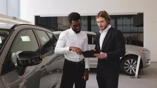 Car Salesman Discussing Options with Customer