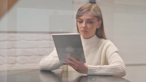 Young Woman Working on Digital Tablet