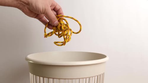 E289 1Shoelaces are thrown into the trash for disposal and recycling. The concept of disposal and pr