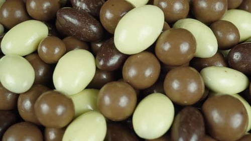 Rotating Hazelnuts And Almonds In Chocolate Glaze.
