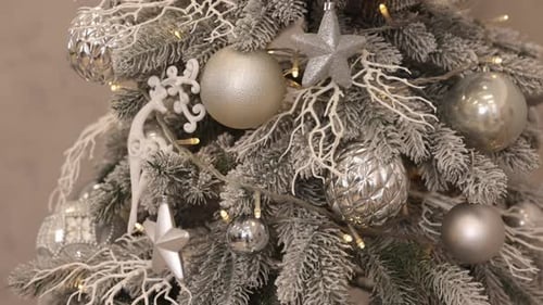 Decorated Christmas tree with white and silver ornaments
