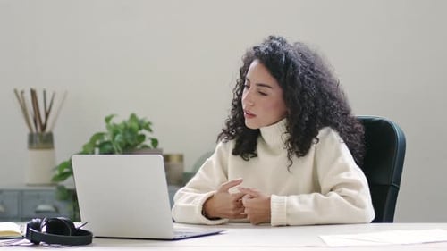Happy Latin Business Woman Having Video Call Hybrid Meeting in Office