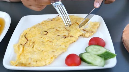 Eating Plain Egg Omelette on Table
