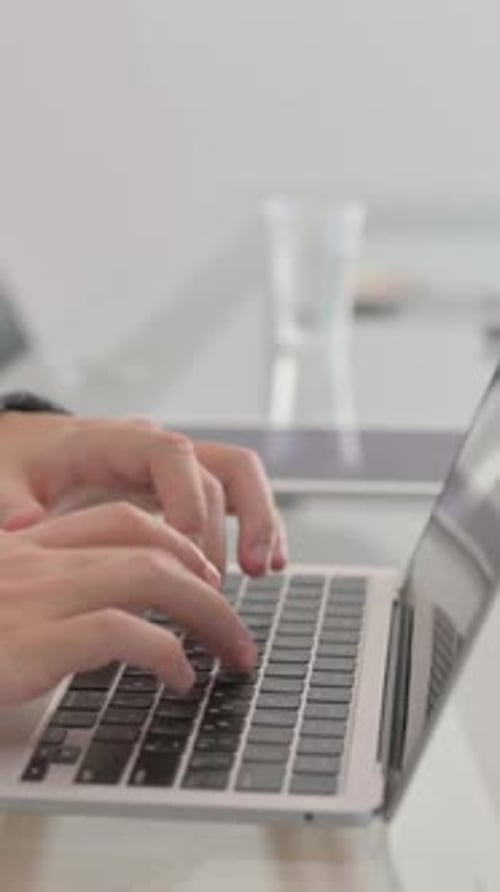 Close up of Hands Typing on Laptop, vertical video