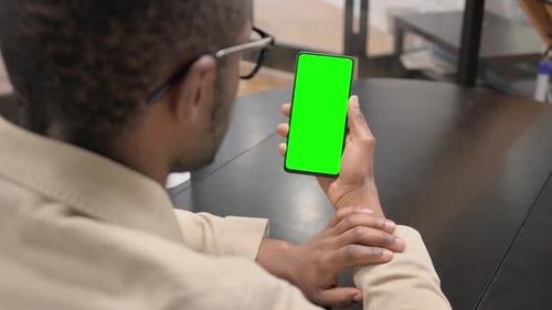 African Man Working on Phone with Green Screen