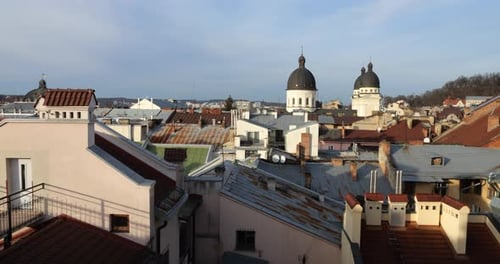 Architecture of an old European city. Shooting tiled roofs and chimneys.