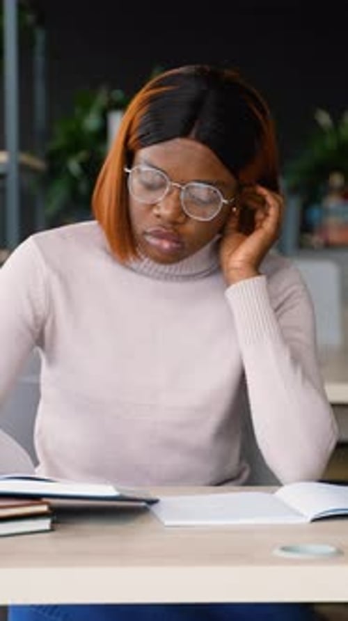 African American Student Reading a Book in the Library