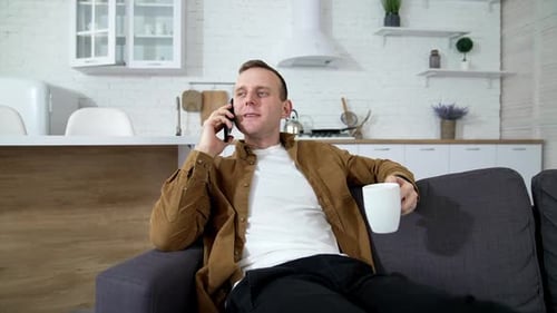 Young Adult Talking on the Phone at Home