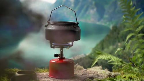 Kettle Steaming on Stove in Mountainous Landscape