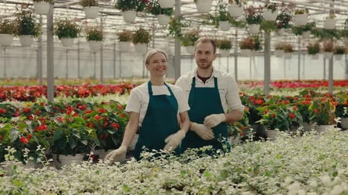 Portrait of the Couple of Garden Workers Crossing Their Arms Looking and Smiling at the Camera on