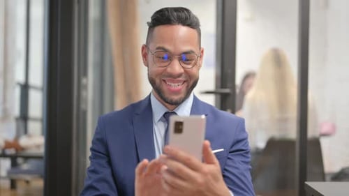 Young Adult Celebrates Business Success With Phone