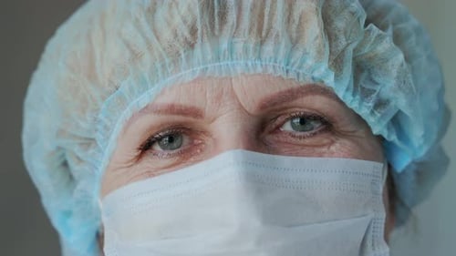 Healthcare Worker Wearing a Surgical Cap and Face Mask