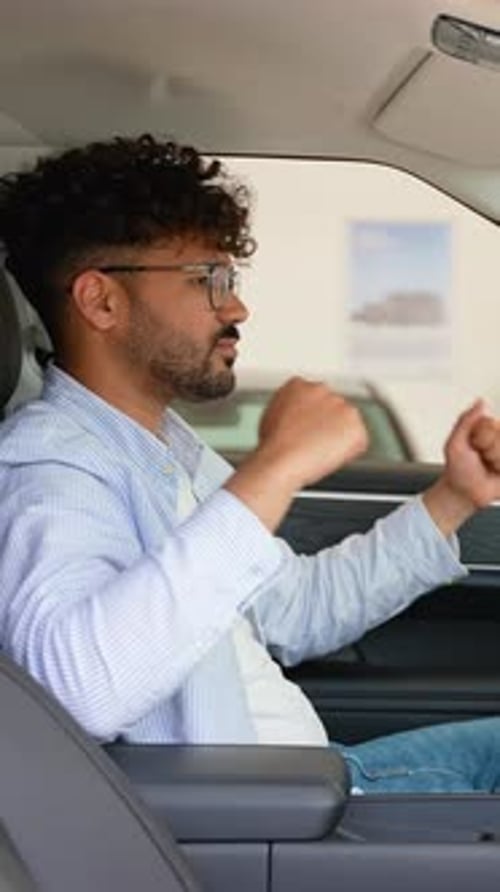 Customer Testing New Car Features in Dealership Showroom