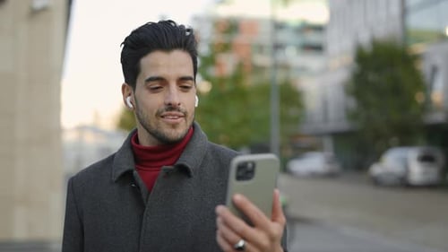 Man Video Chatting with Smartphone Outdoors in the City