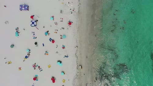 Aerial view of people on beach with waves, holiday and relax on tropical island for summer travel