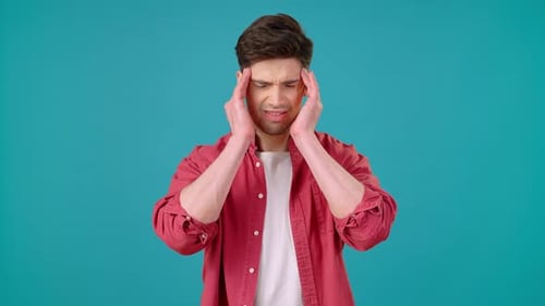 Man Experiencing Headache with Hands to Head