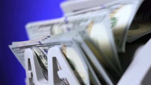 Cash money counting machine. Banknote counter are counting hundred dollar bills. Close-up