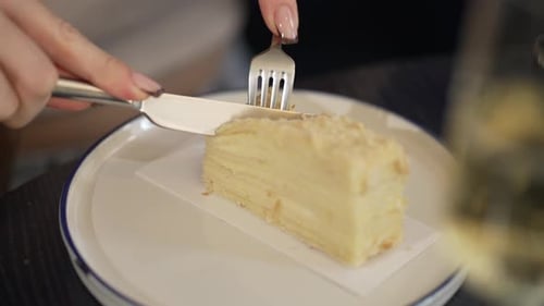 Layered Cake Being Cut with Knife and Fork