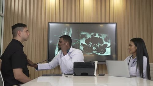 Doctor Listens to Patient Heartbeat with Stethoscope