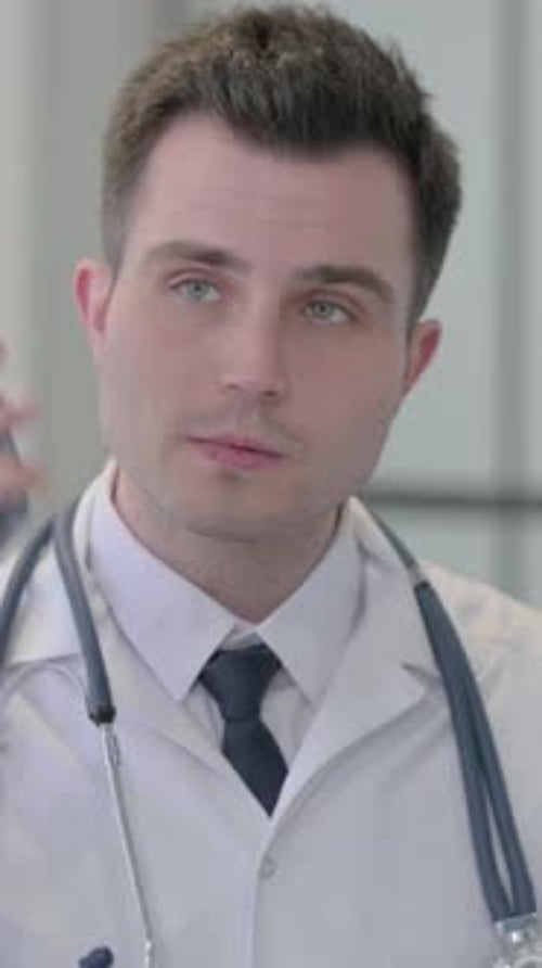 Doctor Talking on Mobile Phone in Clinic Setting