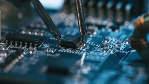 Tin soldering iron solder microchip, macro close up of tools used for fixing computer