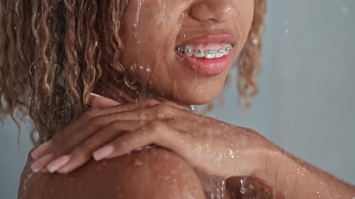 Woman with Braces in Shower, Close Up