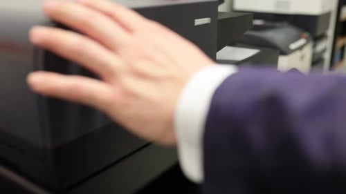 Business Man In Office Using a Photo Copier Scanning Printing Upclose Camera of Hands and Buttons