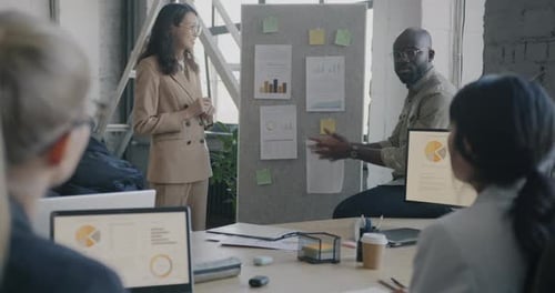 Business Team Meeting with Presentation in Office