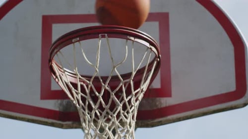 One on One Street Basketball; Closeup of Ball Going Into Basket Action
