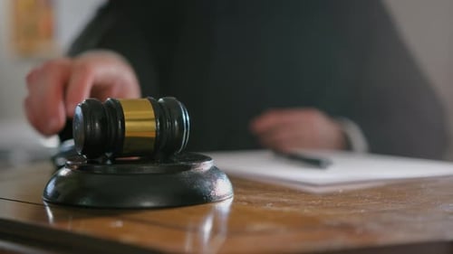 Close Up Footage of Judge's Hand with Wooden Judge Gavel Slow Motion