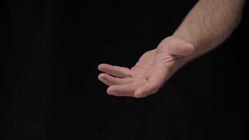 Man's Hand Open Against Black Background