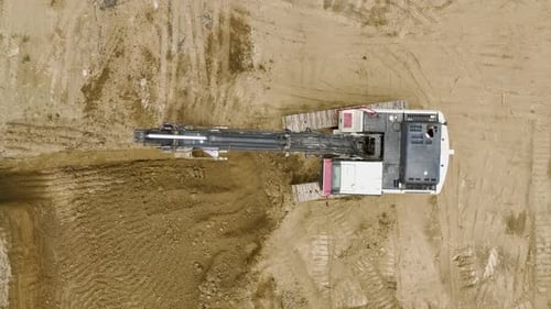 Early Construction Aerial of Excavators and Trucks Clearing Soil