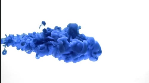Blue ink drops and swirls in water on white