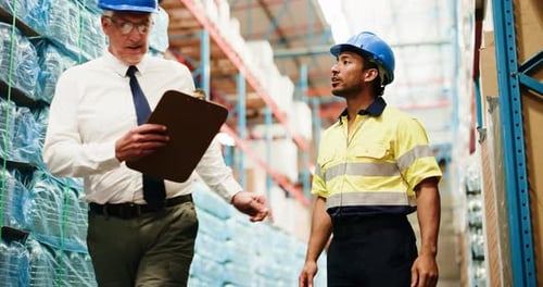 Warehouse, logistics and men with clipboard, discussion and planning stock distribution and talking