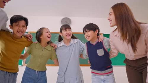 Portrait of Asian adorable student standing with teachers at school.