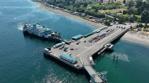 Tilting down aerial shot of a ferry loading passengers.