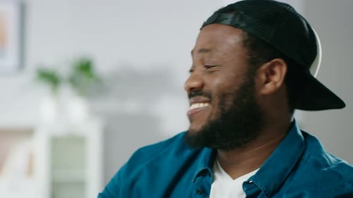 Close-up Shot of the Stylish Black Man Laughing at Something Funny.