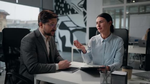Two Caucasian Business Partners Discuss Contract Papers in Office Businesswoman Trader Insurance