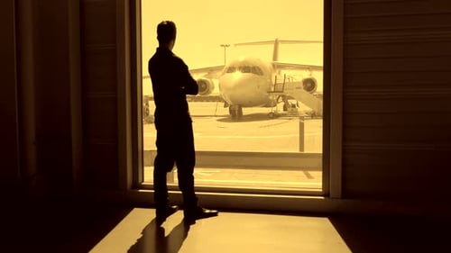 Business Passenger Waiting Inside Airport Gate for Airplane Flight Boarding