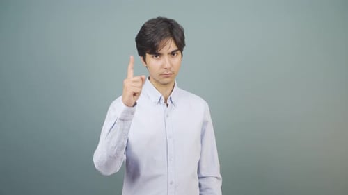 The man is warning by looking at the camera.