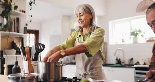 Adults cooking together in brightly lit home kitchen