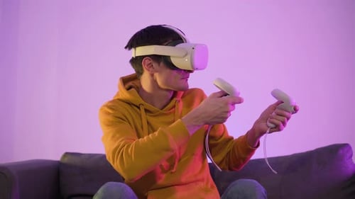 Young Adult Playing VR Video Game on Couch