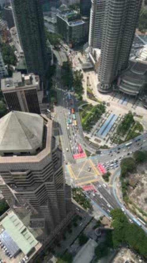 Aerial View of Busy City Intersection in Kuala Lumpur with Modern Skyscrapers