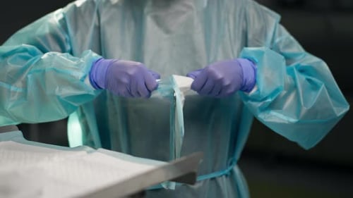 Close Up in a Modern Clinic in a Bright Spacious Operating Room a Doctor Surgeon in Sterile Gloves