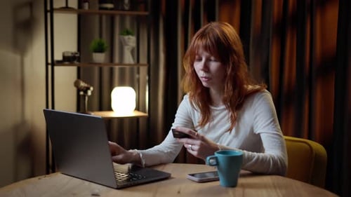 Woman Shopping Online Using Laptop at Home
