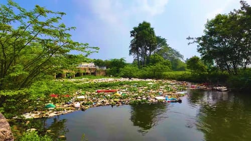 Garbage Obstructing the Flowing River Water - Rightwards