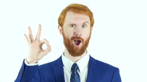 Man in Suit Makes OK Gesture and Winks