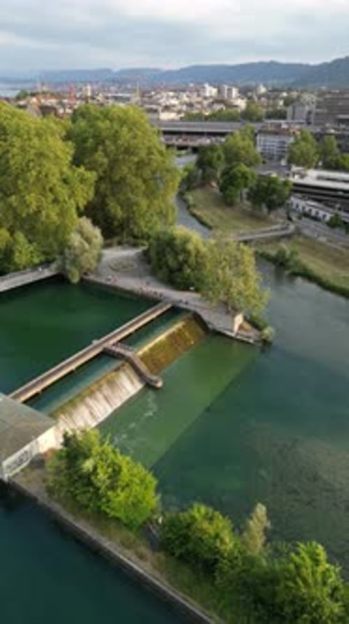 Aerial video of people vacationing along a river in Zurich, Switzerland