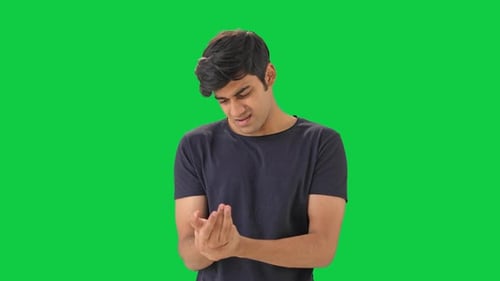 Indian boy having hand pain Green screen